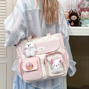 Cute polka dot canvas shoulder bag with large capacity, cute plush pendants, perfect for daily use.