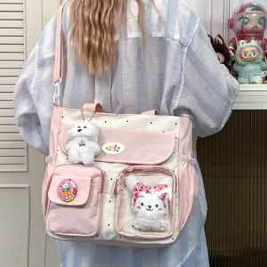 Cute pink polka dot canvas shoulder bag with plush toy charms and transparent pocket for daily use