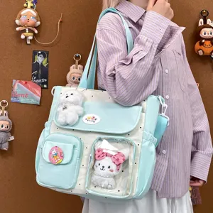 Cute polka dot canvas shoulder bag with clear window and plush toys for daily school travel.