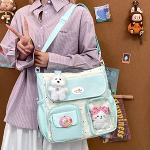 Cute canvas shoulder bag with large capacity, multi-pocket design, and lovely plush pendants.
