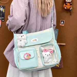 Cute polka dot canvas messenger shoulder bag with clear window and sweet plush doll decor.