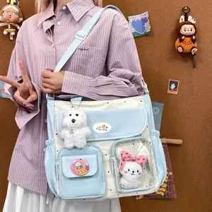 Cute polka dot canvas shoulder crossbody bag with transparent window and plush toy pendants.