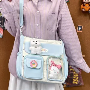 Cute polka dot canvas shoulder bag with cute plush pendant and multiple clear pockets.