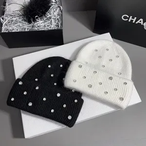 Detailed view of luxurious rhinestone rabbit hair knit hats in black and white colors.