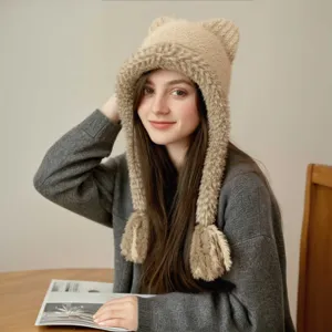 Detailed view of the cute winter warm knitted cat ear hat with plush trim and braided tassels.