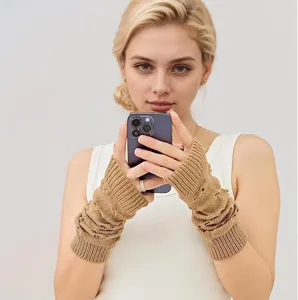 Closeup detail of knitted khaki arm warmers with distressed texture for cozy winter warmth.
