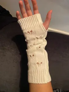 Knit arm warmer detail, heart hollow pattern, soft winter fingerless sleeve accessory.