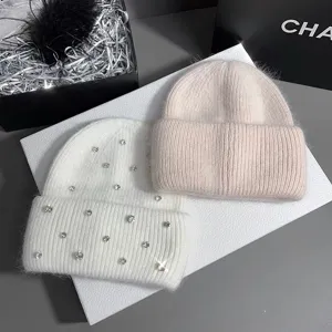 Rhinestone embellished knit beanie detail, soft rabbit hair blend warm winter cap for women.