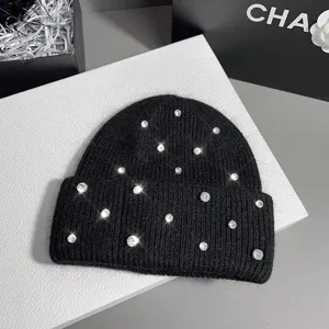 Black rhinestone knit beanie for women, warm winter plush hat with sparkling crystals.