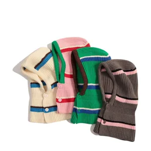 Close-up detail of winter striped knitted balaclava, soft warm hood and bib design.