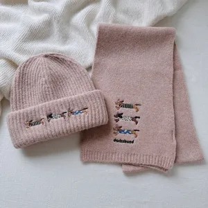 Knitted beanie and scarf set featuring cute embroidered dachshund details for winter warmth.