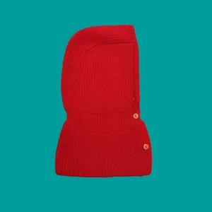 Close-up detail of red knitted balaclava hood, soft warm winter fleece knit with buttons.