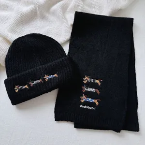 Cute dachshund embroidery detail on black winter knit scarf and beanie set for women.