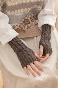 Brown cable knit fingerless gloves detail shot showing soft woolen texture and stylish design.