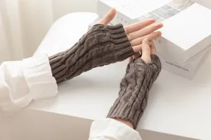 Brown cable knit fingerless gloves detail view, showcasing soft wool texture and winter warmth.