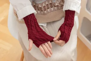 Detailed view of women men cable knit fingerless gloves short winter warm wool arm warmers.
