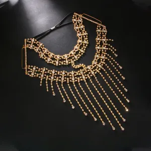 Detail shot of golden rhinestone fringe face mask, glamorous masquerade party headpiece accessory.