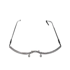 Close-up detail of rhinestone eyeglass frame featuring delicate hanging crystal pendants.