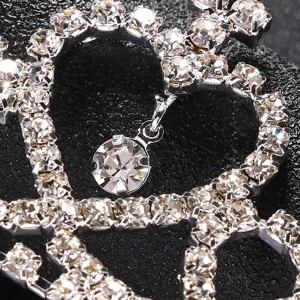 Close-up rhinestone heart headband detail showing sparkling crystal diamonds on silver frame.