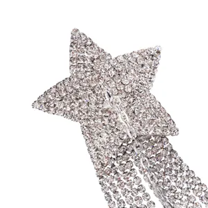 Close-up detail of sparkling rhinestone pentagram star with draping tassel body chain accessory.