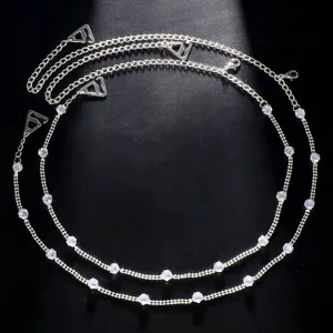 Detailed view of silver rhinestone shoulder chain, sparkling body chain bra strap accessory.