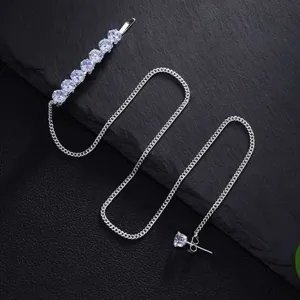 Detailed shot of rhinestones hair clip with tassel chain and earring, stylish fashion jewelry.