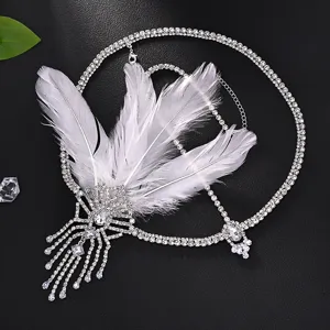 Detailed view of a 1920s vintage flapper feather rhinestone head chain accessory, sparkly.