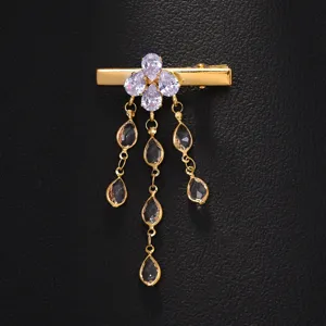 Exquisite rhinestone tassel hair clip detail, golden metal with sparkling pear-shaped crystal drops.