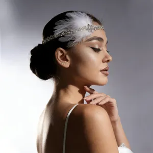 Detailed view of vintage Gatsby feather rhinestone headpiece hair chain for party.