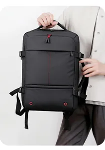 Multifunctional business travel backpack detail showing durable handle, side strap, and red accents.