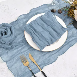 Detail view of the rustic blue gauze table runner with natural wrinkles and elegant folds.