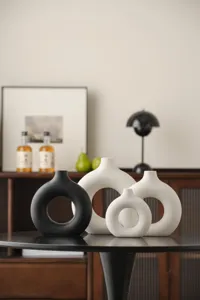 Nordic ceramic ring vase scene, modern abstract circle hollow design for home decor.
