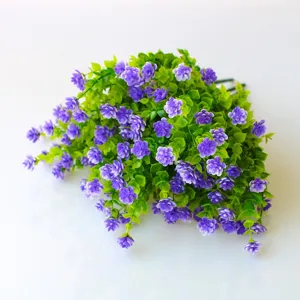 Artificial purple flower bouquet detail shot, plastic plant wall decoration for home garden decor.