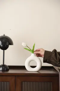 Nordic ceramic donut vase detail shot, minimalist white ring flower container for home decor.