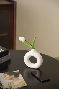 Nordic ceramic donut vase with white tulip flower, modern minimalist aesthetic home decor piece.