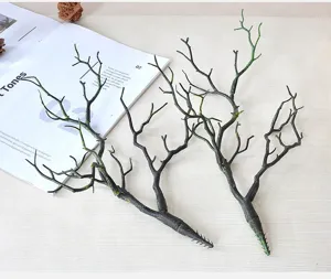 Close-up detail of artificial dark branch decor on tabletop prop, ideal for creative floral display.