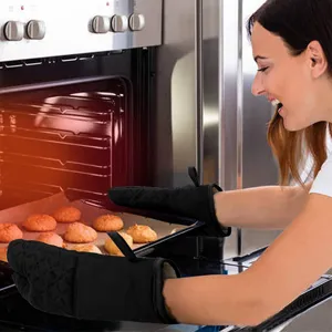Black silicone oven mitts detail showing heat resistant protection during home baking.