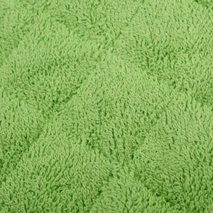 Grüner Baumwoll Frottee Handtuch Stoff Detail Makroaufnahme, weiche Textur für Küchenmatte.