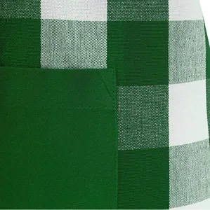 Close-up detail of green and white plaid kitchen apron pocket and woven fabric texture.