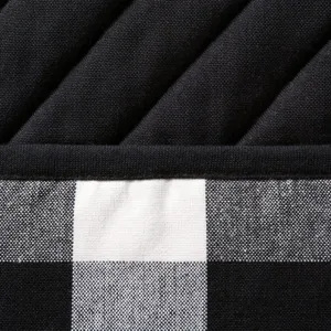 Close-up detail shot of the thick black and white buffalo plaid quilted fabric material.