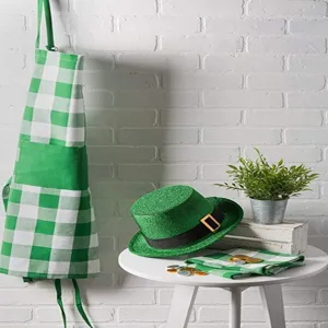 Green and white checkered kitchen apron detail view showcasing festive holiday decoration.