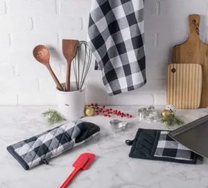 Detailed view of black and white buffalo plaid kitchen oven mitt pot holder and towel set.