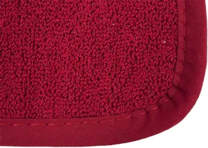Gros plan detaille du tapis isolant de cuisine en tissu eponge rouge epais et coutures.