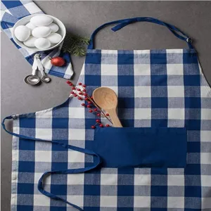 Detailed view of blue white checkered kitchen apron with pocket, home cooking tool.
