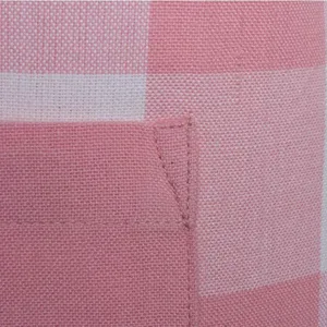 Close-up detail of pink and white checkered apron fabric with fine pocket stitching and texture.