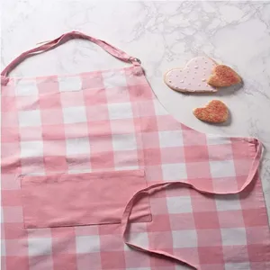 Detailed view of pink and white checkered kitchen apron featuring convenient front pocket.