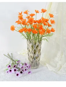 Detailed view of artificial orange cosmos and purple flowers in a glass vase, decor prop.
