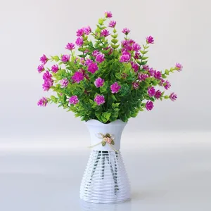 Artificial purple flowers in white plastic woven vase for home and office decor.