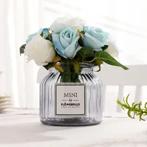Artificial blue white rose bouquet with glass vase for home decor and wedding photo props.