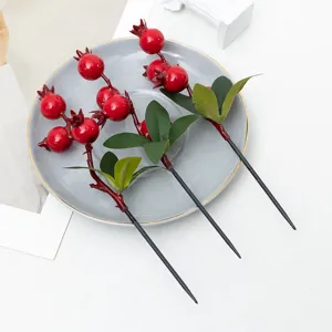 Rami di melograno artificiali per decorazioni casa, dettaglio composizione floreale.
